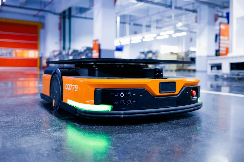 an orange and black vehicle in a garage